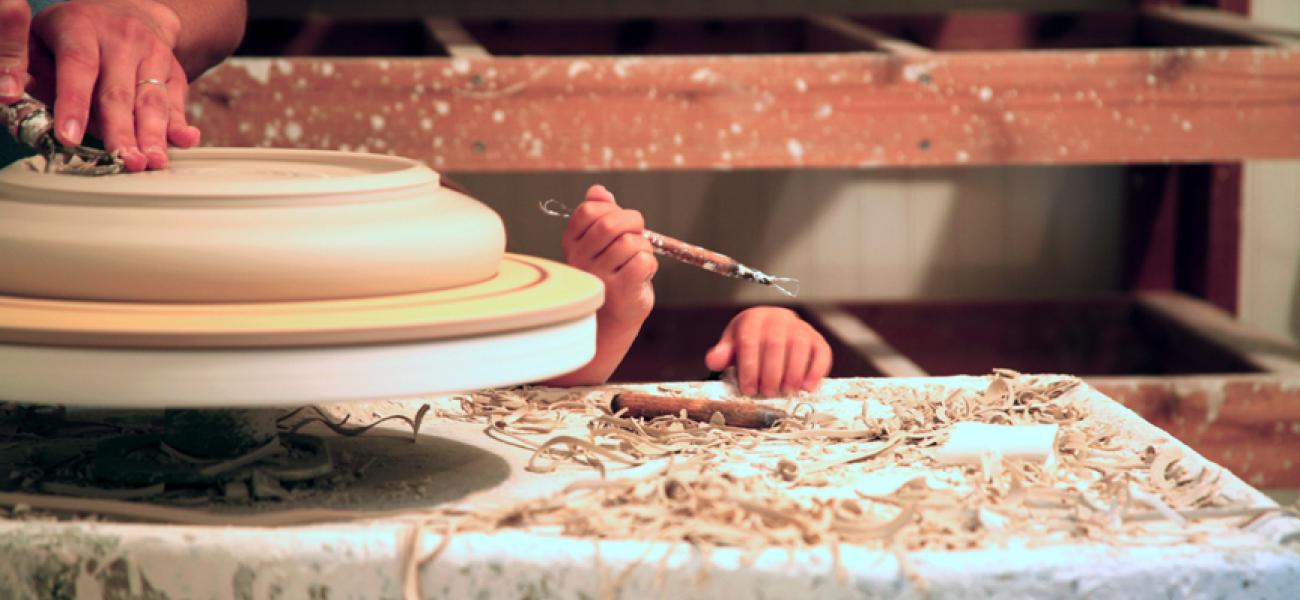 Hands of Amy Smith and her daughter, at the potter's wheel. 