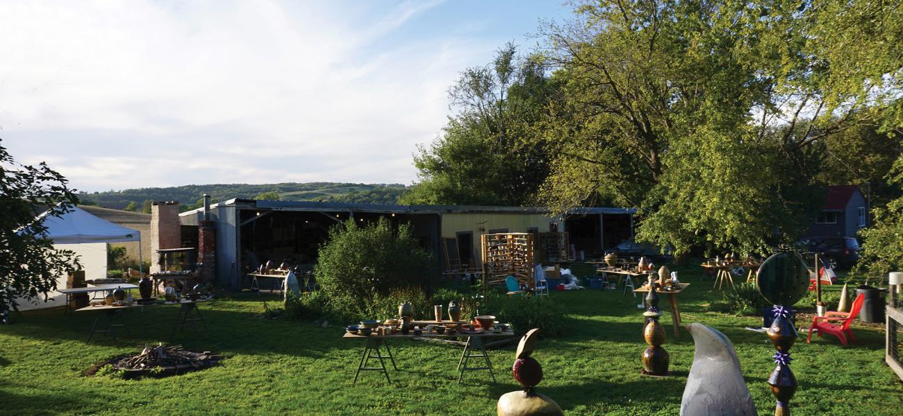 Setting up the big table studios the evening before the Omaha North Hills Pottery Tour, 2016. Photograph by Colin Rohne.