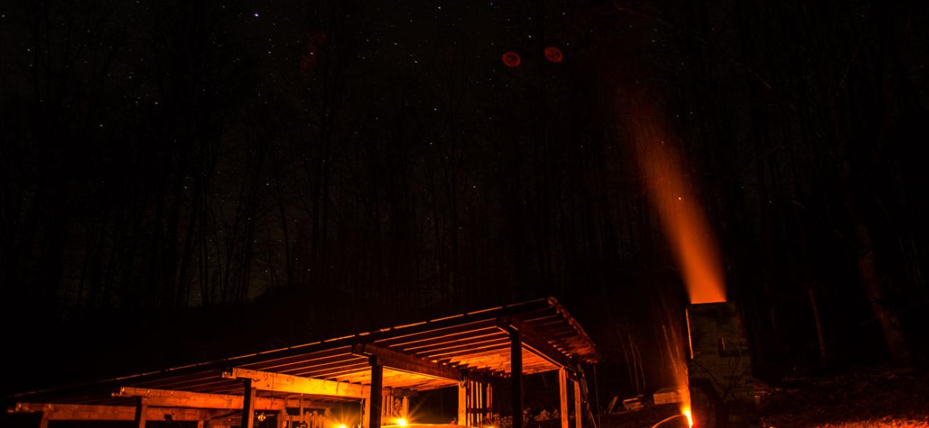 Noah Hughey-Commers’s anagama firing at night, Muddy Creek Pottery, Lovingston, Virginia. Photograph by Peter Rausse, 2015.