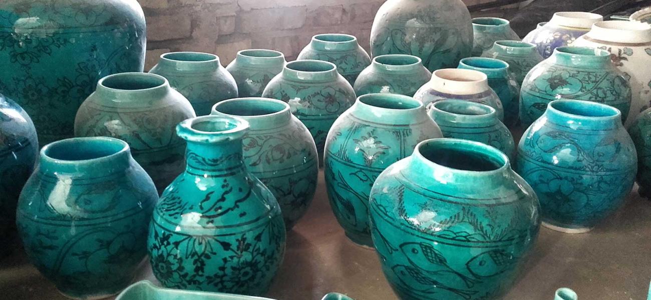 These turquoise pots represent a changing pottery tradition. The fish motif  is traditional to the area around the village of Shah Reza, but the forms  and color cater to current fashions.