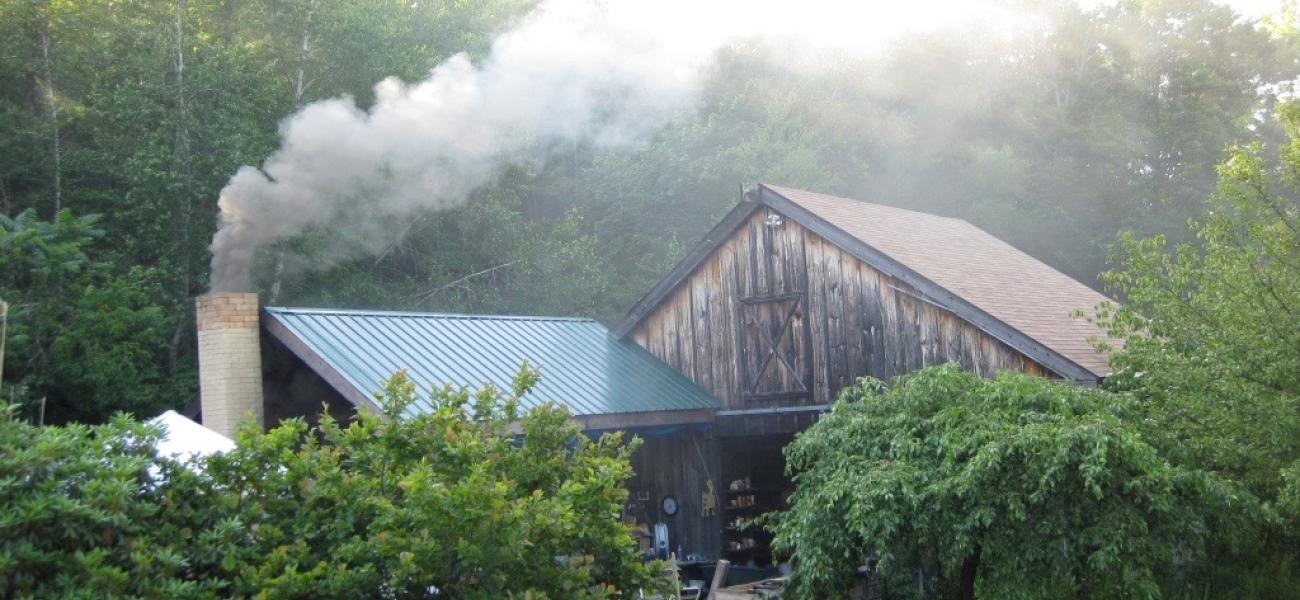 Entrance to Magnusson's studio barn and kiln shed, with a firing underway. Photo by the author, 2010.