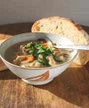 Nathalie Royston, chicken and mushroom soup in brown stoneware bowl, glazed in alpine white, decorated with a leaf design.