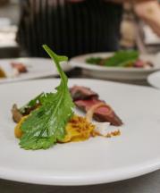 Ceramic plate by Tim Compton, beef course by Chef Alan Sternberg, 2017. Plate is wheel-thrown, 14x14x3 in. Photograph by Audra Sternberg. 