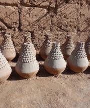 Astour, near Zagora, Oasis region. These unique pieces, nearly 30” high, were commissioned by someone in a big city as decorative pieces in a hotel or mall. The white coating is ash from the fire pit.