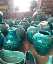These turquoise pots represent a changing pottery tradition. The fish motif  is traditional to the area around the village of Shah Reza, but the forms  and color cater to current fashions.