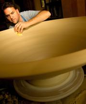 Ben making a large bowl for an installation, 2008. 16x48x48 in. Photograph by Jerry Wolford