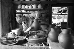 Jane Herold bowing handles on jugs in her studio, Palisades, New York. Photo by Susan Stava.